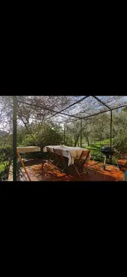 a picnic table with a tent and a grill at Casa Pizzillo in Campofelice di Roccella