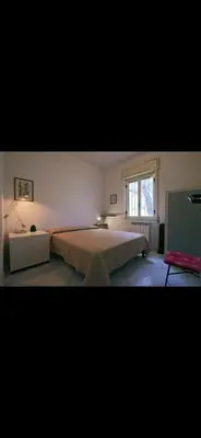 a bedroom with a large bed and a window at Casa Pizzillo in Campofelice di Roccella