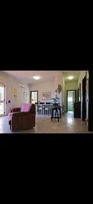 a living room with a couch and a table at Casa Pizzillo in Campofelice di Roccella