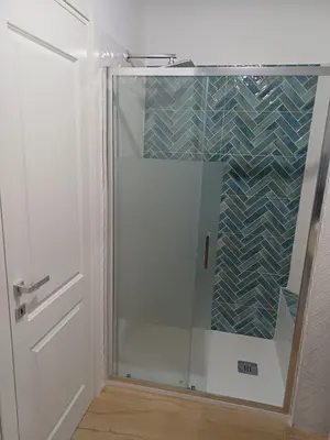 a shower with a glass door in a bathroom at Dotto 25 Apartment in Palermo