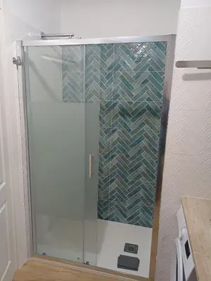 a shower with a glass door in a bathroom at Dotto 25 Apartment in Palermo