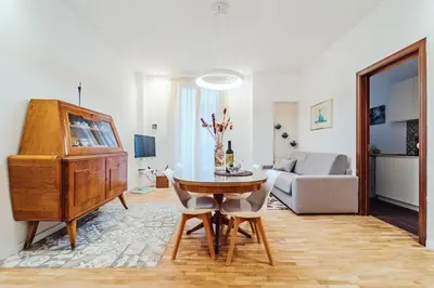 a living room with a table and a piano at Sofia's House - Comfort e Relax vicino Stazione Notarbartolo in Palermo