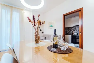 a dining room with a glass table with wine glasses at Sofia's House - Comfort e Relax vicino Stazione Notarbartolo in Palermo