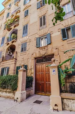 a building with a wooden door in front of it at Sofia's House - Comfort e Relax vicino Stazione Notarbartolo in Palermo