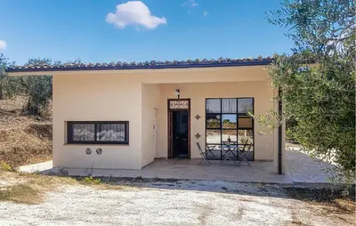 a small house with a patio and a door at Casetta San Giovanni in Giuliana