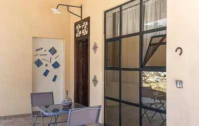 a dining room with a table and a glass door at Casetta San Giovanni in Giuliana