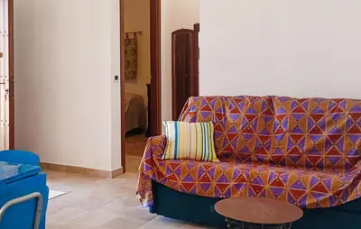 a living room with a couch and a table at Casetta San Giovanni in Giuliana