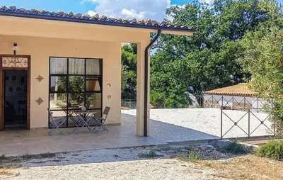a house with a patio with a table in it at Casetta San Giovanni in Giuliana