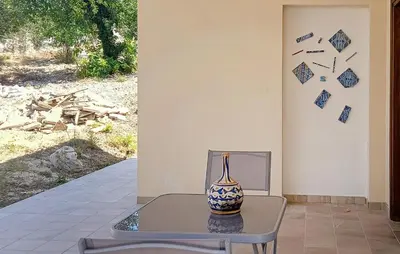 a vase sitting on a table in front of a wall at Casetta San Giovanni in Giuliana