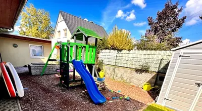 a playground with a slide in front of a house at Appartamento Calabris in Bagheria