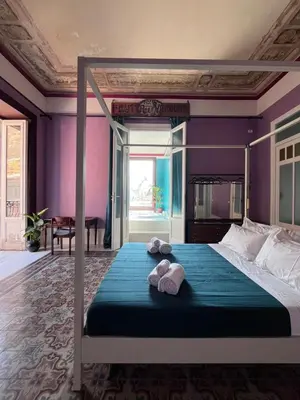 a bedroom with a large bed with towels on it at Galleria Cutò - Art Boutique Rooms in Palermo