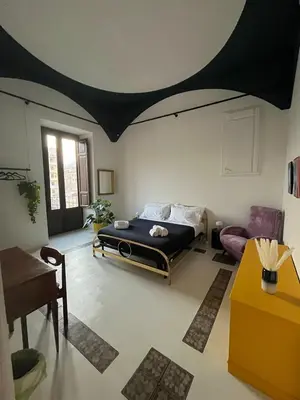 a bedroom with a bed with a black ceiling at Galleria Cutò - Art Boutique Rooms in Palermo