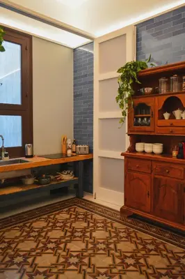 a kitchen with a table and a shelf and a window at Galleria Cutò - Art Boutique Rooms in Palermo