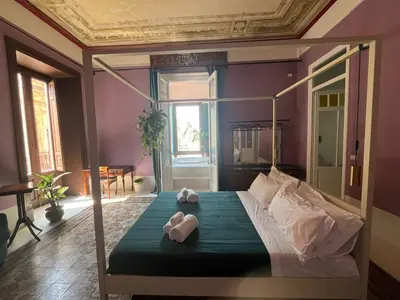 a bedroom with a bed with two towels on it at Galleria Cutò - Art Boutique Rooms in Palermo