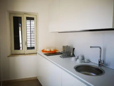 a kitchen counter with a sink and a window at Cielo D'Alcamo Palazzo Mazzini in Alcamo