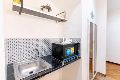 a kitchen with a sink and a tv on a counter at Balarm-Boutique Rooms in Palermo