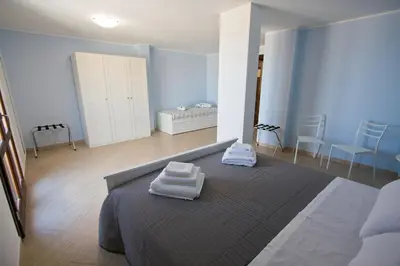 a bedroom with a bed with two towels on it at Casa Oltremare UnmarediBlu in San Vito lo Capo
