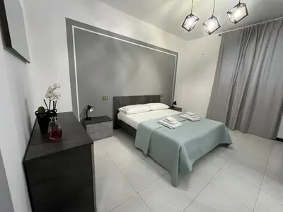 a bedroom with a bed and a table with towels at D'Aversa Rooms in Marineo