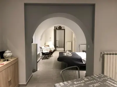 a bedroom with a bed and a table in a room at Al Bastione Holiday House in Palermo