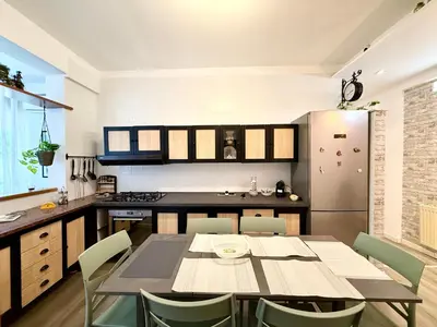 a kitchen with a table and chairs in a room at La Coccola in Palermo