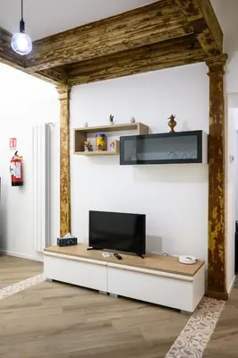 a living room with a flat screen tv on a wall at Casa Mazzarino - Exclusive Vucciria Apartment in Palermo