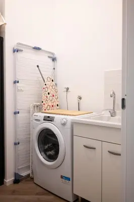 a washing machine in a kitchen next to a sink at Casa Mazzarino - Exclusive Vucciria Apartment in Palermo