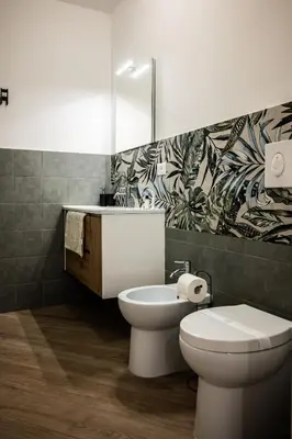 a bathroom with a toilet and a sink at Casa Mazzarino - Exclusive Vucciria Apartment in Palermo