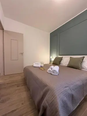 a bedroom with a large bed with towels on it at Le case del Cardinale, La casetta di nonna Elvira in Palermo