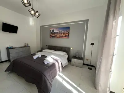 a bedroom with a large bed in a room at D'Aversa Rooms in Marineo