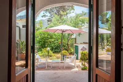 an open door to a patio with an umbrella at Isola delle Femmine Apartments by Wonderful Italy in Isola delle Femmine