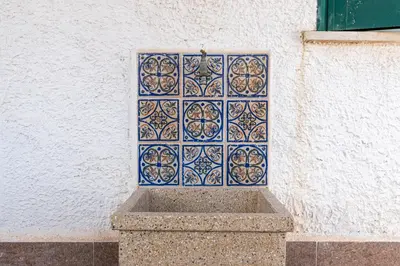 a blue and white tile on a wall at Isola delle Femmine Apartments by Wonderful Italy in Isola delle Femmine