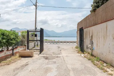 an empty street with an open gate next to a building at Isola delle Femmine Apartments by Wonderful Italy in Isola delle Femmine