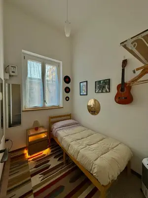 a bedroom with a large bed and a large window at Urban Space 49 in Palermo