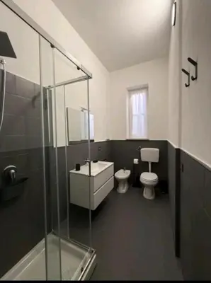 a bathroom with a white sink and a mirror at Urban Space 49 in Palermo