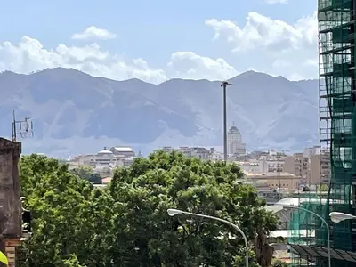 a view of a city with mountains in the background at Palermo Home in Palermo