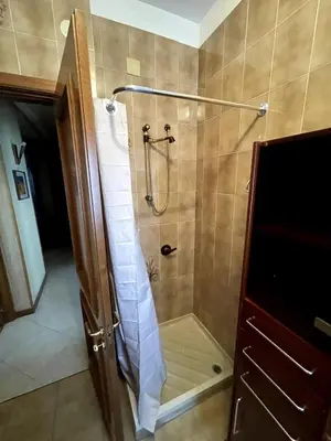 a bathroom with a shower with a glass door at Palermo Home in Palermo