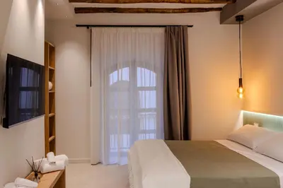 a bedroom with a bed and a large window at Holivù Apartments in Palermo