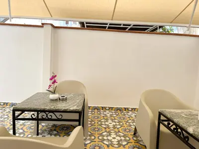 a room with a table and chairs and a tile floor at Palermo central stay in Palermo