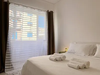 a bedroom with two towels on a bed with a window at Palermo central stay in Palermo