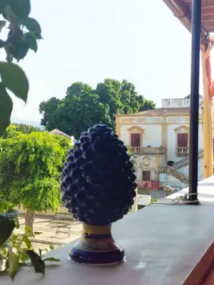 a pomegranate ball on a vase on a balcony at Dimora Filangeri in Santa Flavia