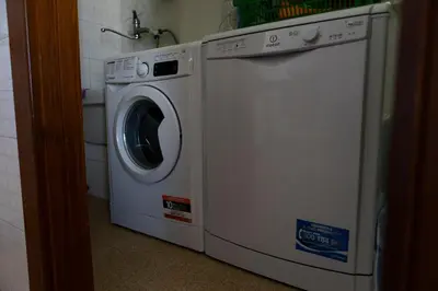 a washer and dryer sitting in a bathroom at I Piani Apartment in Trabia