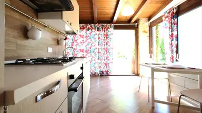 a kitchen with a stove and a counter with a window at Visitsicilia Villa Cialoma in Scopello