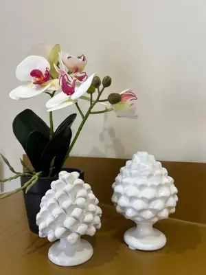 three white vases sitting on a table with a plant at Notarbartolo Casa Centrale in Palermo