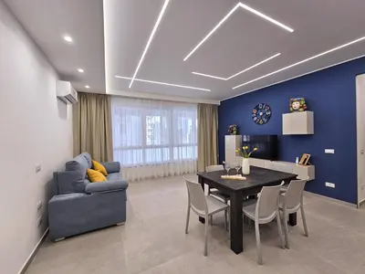 a living room with a table and a blue wall at Al Centro di Palermo - Casa Bertolino in Palermo