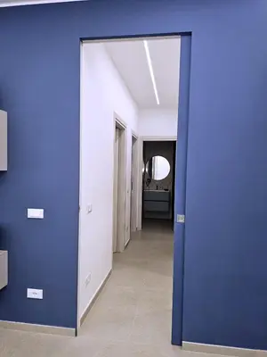 a room with a blue wall and a hallway at Al Centro di Palermo - Casa Bertolino in Palermo