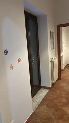 an empty hallway with a door and a tile floor at La Casa di Cat in Palermo