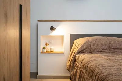 a bedroom with a bed and a light on the wall at Loft San Basilio in Palermo