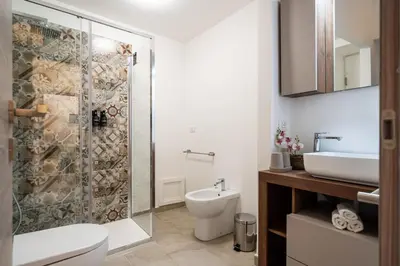 a bathroom with a shower and a toilet and a sink at Loft San Basilio in Palermo