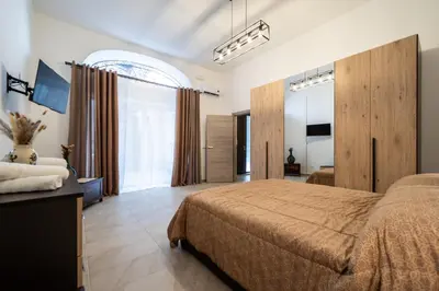 a bedroom with a large bed and a large window at Loft San Basilio in Palermo