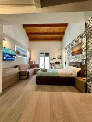 a bedroom with a large bed and a couch at Casa Luma Palermo in Palermo